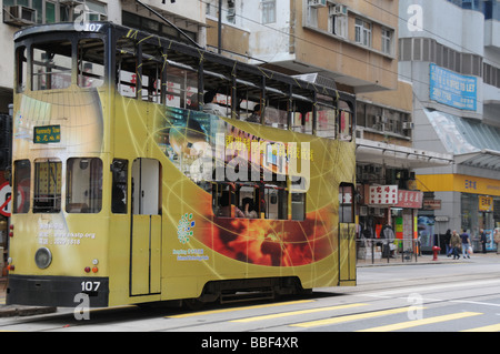 double decker tram with advertising in downtown Hong Kong Stock Photo