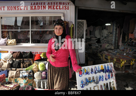 At Kaymakli, an underground town in Cappadocia cut into the volcanic rock, a woman was selling items handmade by local women. Stock Photo