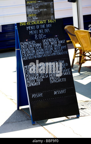 Bilingual menu board, sign in two languages, English and Spanish, outside a chiringuito restaurant in Fuengirola, Costa del Sol, Stock Photo