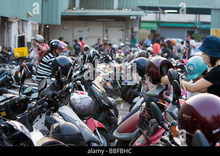 Motorbike, motorcycle scooters parked in rows at Yi Dian Li Traditional Afternoon Market, Beitun District, Taichung City, Taiwan Stock Photo