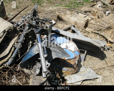 old scooter motorbike dumped on derelict ground Stock Photo