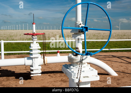 a pipeline for the distribution of natural gas wind turbins in the background Stock Photo