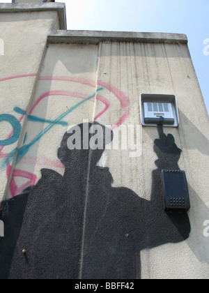 dark person graffiti ringing doorbell on property in street road Stock Photo