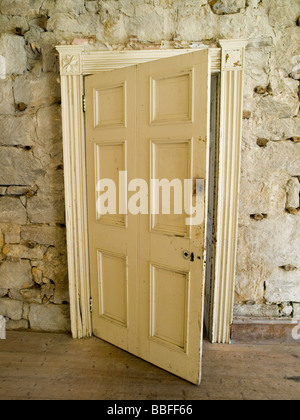 An old wooden door inside the hall at Brinkburn Priory, near Rothbury in Northumberland England UK Stock Photo