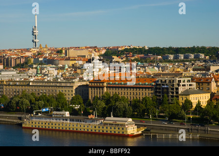 Restaurant boat moored along River Vltava with Zizkov and TV tower in background in central Prague Czech Republic Europe Stock Photo