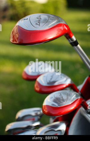 A full set of red Golf clubs in a bag for a woman on natural blurred blurry background from above overhead outside outdoors background USA US hi-res Stock Photo