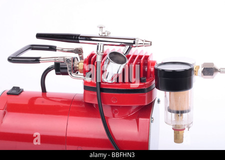 Airbrush and compressor detail on white background Stock Photo