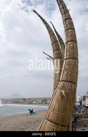 Pointed totora reed rafts surfed on by fishermen. Huanchaco, a beach and vacation town in the northern city of Trujillo, Peru. Stock Photo