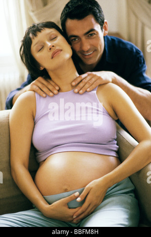 Man massaging pregnant wife's shoulders Stock Photo