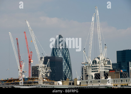 City of London Construction Cranes and Buildings, including the Gherkin, Swiss Re Building, 30 St Mary Axe, London, England, UK Stock Photo