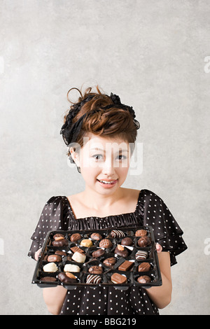 Woman with tray of chocolates Stock Photo