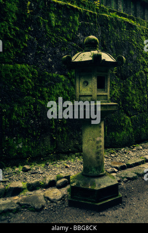 Mossy stone lantern. Walkway from Toshogu Shinto Shrine to Futurasan Shinto Shrine complex. Nikko. Tochigi Prefecture. Japan. Stock Photo