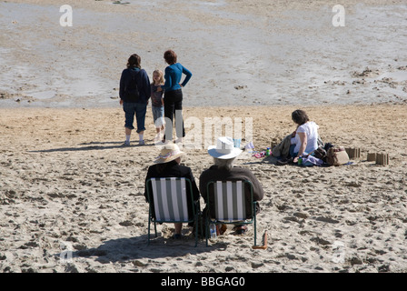 Holidaymakers sitting in deckchairs on the beach 'St Ives' Cornwall UK Stock Photo