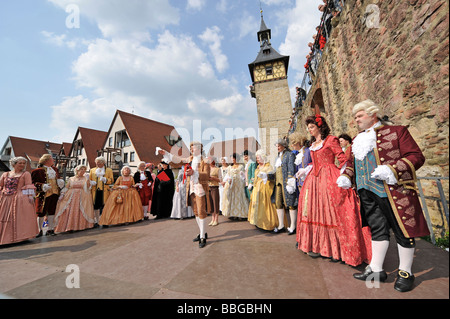 Life in the Baroque period of the 18th Century, court society in Venetian clothes in the courtyard with gate tower, Schiller Stock Photo