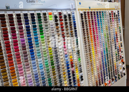 Rack of many different colored spools of thread for sewing. Charles Lupica. Stock Photo