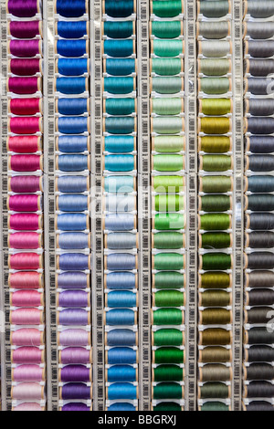 Rack of many different colored spools of threads for sewing Stock Photo