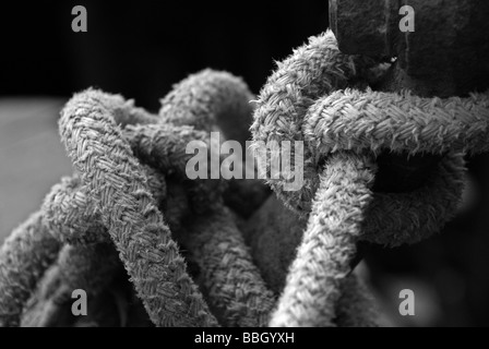 Knots in Ropes around Steel Post, monochrome Stock Photo