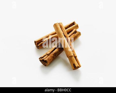 Cinnamon sticks overlaying on white studio background Stock Photo