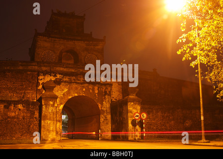 Light trails from a motorbike passing through the 'Ngan Gate' at night, ancient entrance to Hue Citadel, Vietnam, Long exposure Stock Photo