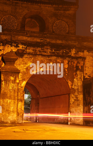 Light trail from a motorbike passing through the 'Ngan Gate' at night, ancient entrance to Hue Citadel, Vietnam, Long exposure Stock Photo