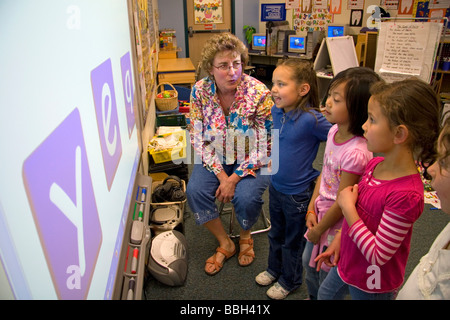 Kindergarten students use an interactive whiteboard in the classroom of a public school in Boise Idaho USA MR Stock Photo