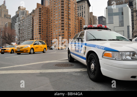 NYPD Police Patrol Car and yellow taxi cabs Manhattan midtown New York ...