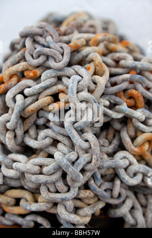 A pile of old textured and rusty chains macro shot with a narrow depth of field Stock Photo