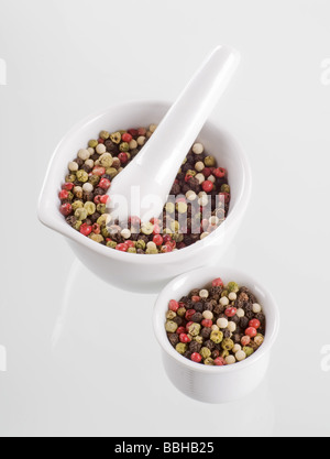 Mix of peppercorns in a porcelain mortar Stock Photo