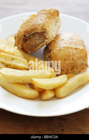 Authentic British Style Sausage Roll with Chips Served On A Plate With No People Stock Photo