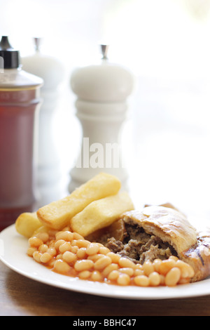 Authentic Cornish Pasty Filled With Meat and Vegetables with Chips and Baked Beans In Tomato Sauce With No People Stock Photo