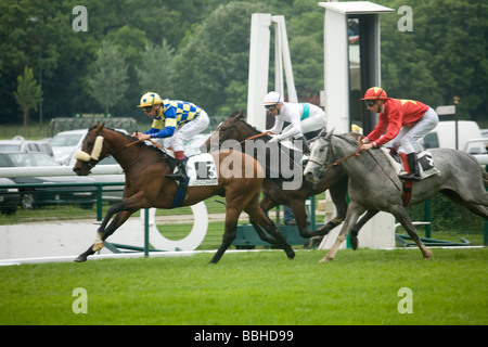 Horses pass the finishing post at Longchamp racecourse in Paris France Stock Photo
