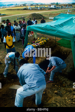 Members of Pietermaritzburg Christian Fellowship friends and family take it in turn to fill in the grave of a community heroine Stock Photo