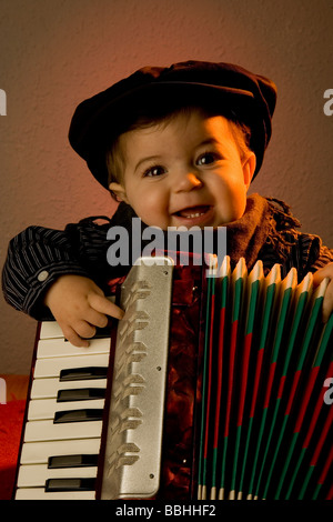 Little baby playing accordion Stock Photo