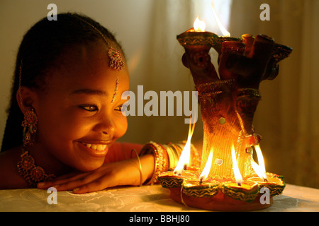 12 year old Hindu devotee Latoya Khaba lights clay lamps on 21 October 2006 in Durban during the Hindu Festival of Diwali Stock Photo