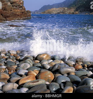 THESE BOULDERS ARE WORN SMOOTH BY THE CONSTANTLY SURGING SURF IN A BAY AT STORMS RIVER MOUTH Stock Photo