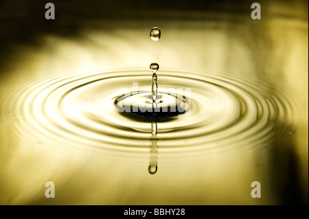 Waterdrop falling making a splash. Stock Photo