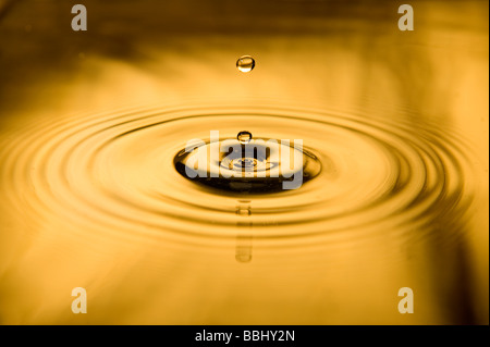 Two drops of water falling. Making small waves on the surface Stock Photo