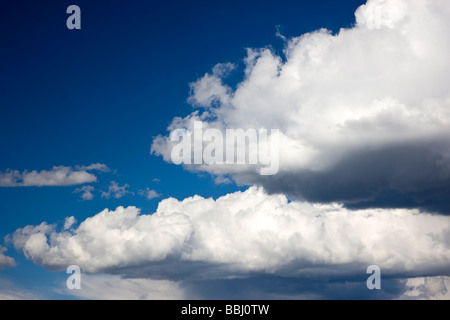 Puffy white cumulous clouds against a clear blue sky between Gunnison and Parlin Colorado USA Stock Photo