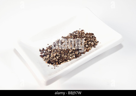 Cutout of Freshly Ground Black pepper Piper nigrum on white background Stock Photo