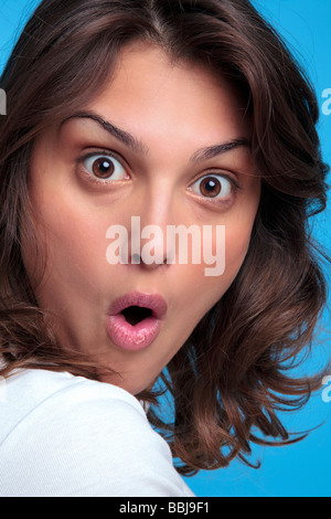 Portrait of an attractive young woman with a shocked expression of her face Stock Photo