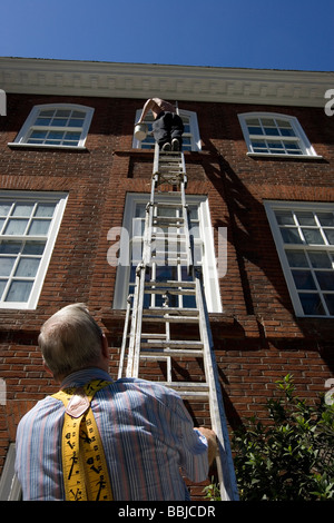 two painters and a ladder Stock Photo