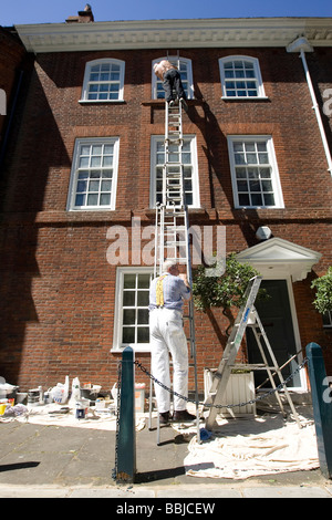 two painters and a ladder Stock Photo