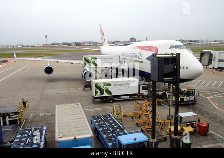 Gategourmet catering supplier trucks loading a BA 747 jet aircraft at ...