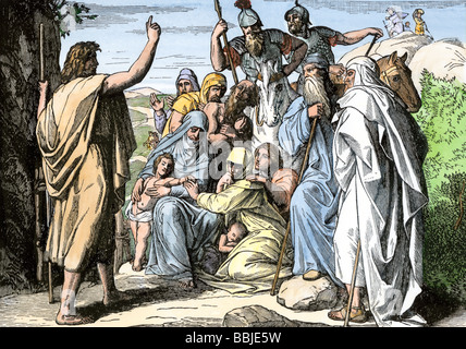 John the Baptist foretelling the coming of a messiah. Hand-colored woodcut Stock Photo