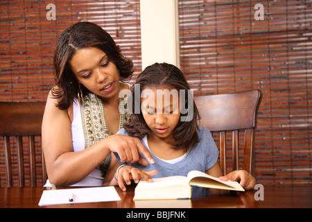 Mother and daughter doing homework together Stock Photo