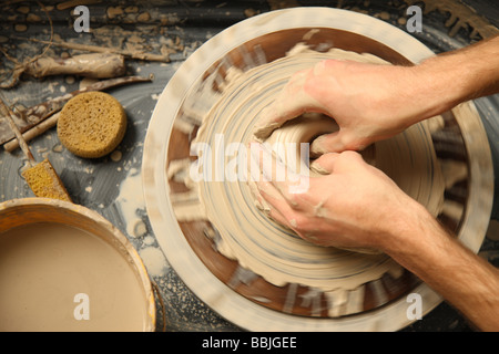 Closeup of hands working on pottery wheel Stock Photo