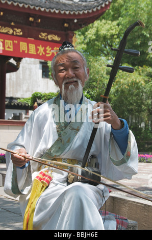 Old bearded man playing Erhu or two stringed chinese violin Tongli Jiansu China Stock Photo
