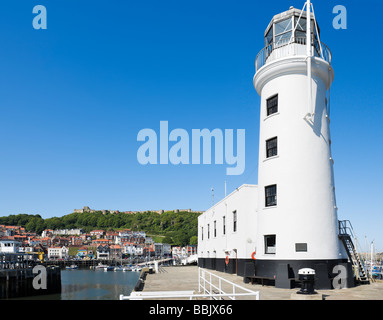 The lighthouse and harbour with the Castle behind, Scarborough, East Coast, North Yorkshire, England Stock Photo