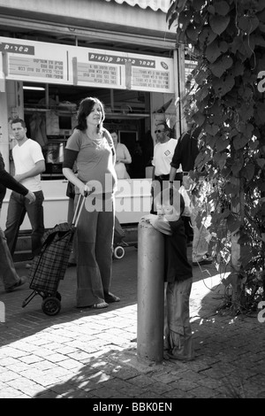 City scene .Child and mother in the open market Stock Photo