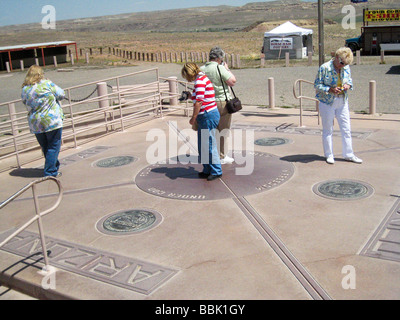 New Mexico Colorado Arizona Utah Four Corners Monument woman looks at ...